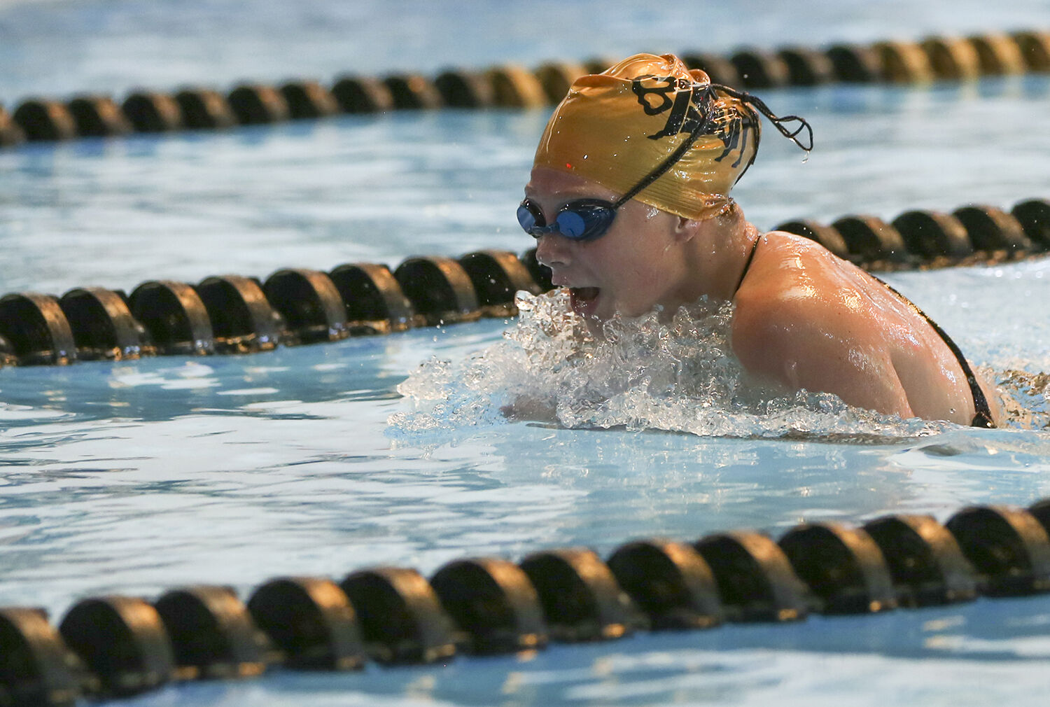 Makenna Lambert rises out of the water during the breast stroke